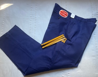 May include: A pair of dark blue pants with a red label that says "Loppy" on it. The pants have a pocket on the right side and a ruler is sticking out of the pocket.