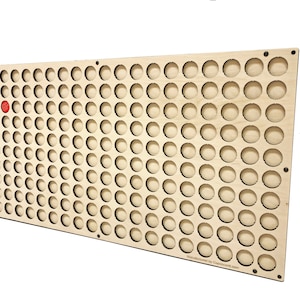 May include: A wooden board with 100 circular cutouts, designed to hold bottle caps. A single red bottle cap is placed in one of the cutouts.
