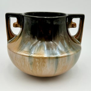 May include: A ceramic vase with two handles, featuring a brown, black and silver iridescent glaze. The vase has a rounded body and a wide opening.