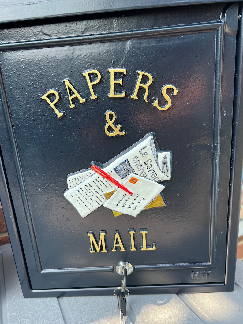 May include: Black mailbox with gold lettering that reads "PAPERS & MAIL". The mailbox has a 3D design of papers and envelopes with a red pencil on top.