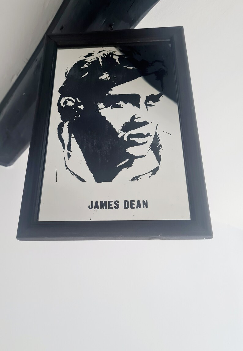 May include: Black and white framed mirror with a silhouette of James Dean's face and the text "JAMES DEAN" below.