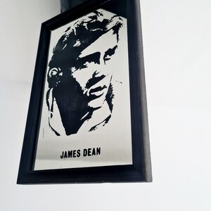 May include: Black and white framed mirror with a silhouette of James Dean's face and the text "JAMES DEAN" below.