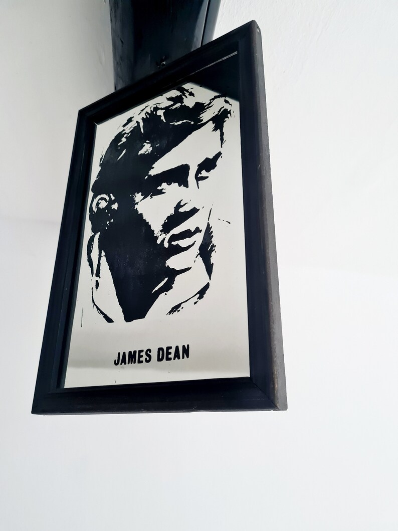 May include: Black and white framed mirror with a silhouette of James Dean's face and the text "JAMES DEAN" below.