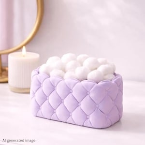 May include: A rectangular lavender storage container featuring a tufted, button-detailed exterior texture. The container is filled with a collection of soft, round, white cotton balls. The design is consistent with a fabric-covered organiser.