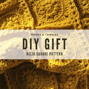 May include: Close-up of a mustard yellow crocheted blanket. The blanket is made of square patterns with a floral design in the center. Text on the image reads "HOOKS & TANGLES DIY GIFT HELIO SQUARE PATTERN".