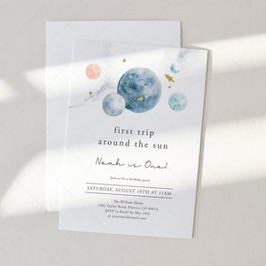 May include: A blue and white watercolour illustration of planets and stars with the text "first trip around the sun Noah is One!" Join us for a birthday party Saturday, August 10th at 11am The William Home 1382 Taylor Road, Denver, CO 80014 RSVP Emily by May 10th at youromailemail.com