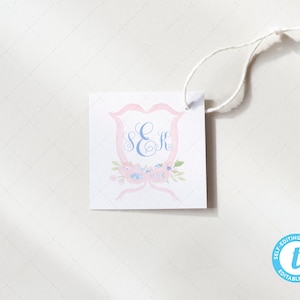 May include: A white square gift tag with a pink and blue floral design and the monogram "S&R". The tag has a hole at the top for string or ribbon.