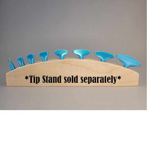 May include: A set of eight blue paint tips displayed on a wooden stand. The stand is curved and has the text "*Tip Stand sold separately*" printed on it.