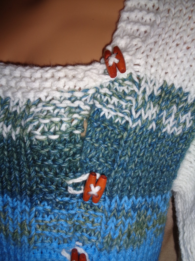 Sweater jacket in white bright summer sky blue and bluegreen variegated yarn Warm and comfy for outside. Size 1X 22-24