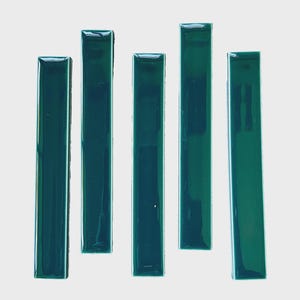 May include: Five rectangular tiles with a glossy, deep emerald green finish. Each tile features a smooth, reflective surface and straight, clean edges, arranged vertically in a parallel formation to showcase the uniform color and texture.
