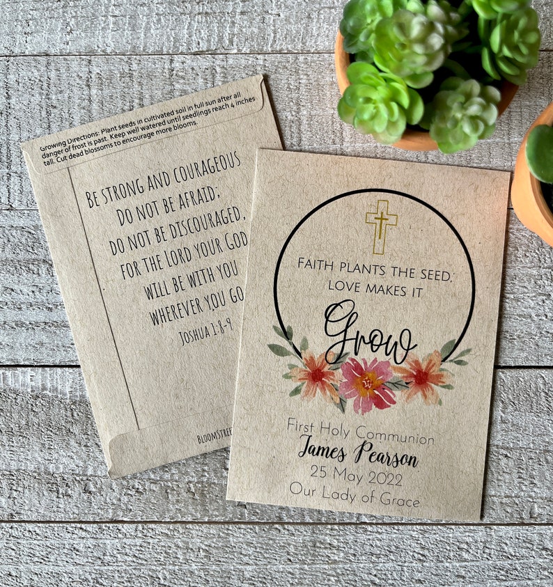 May include: A brown paper card with a floral wreath and a cross. The text reads "Faith plants the seed, love makes it grow". Below the wreath is the text "First Holy Communion James Pearson 25 May 2022 Our Lady of Grace".