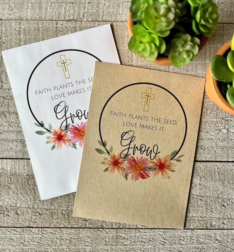 May include: Two seed packets with a floral design and the text "Faith plants the seed. Love makes it grow."  The packets are on a wooden surface.