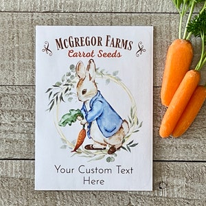 May include: A white seed packet with a watercolor illustration of a rabbit holding a carrot. The packet has the text "McGregor Farms Carrot Seeds" and "Your Custom Text Here".