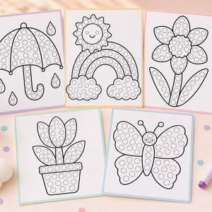 May include: Dot marker art templates with an umbrella, rainbow, flower, tulip, and butterfly designs. Each image is outlined in black with circles for dot markers. A purple marker and a set of colourful markers are also visible.