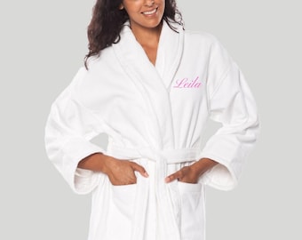 May include: White bathrobe with a pink embroidered name "Leila" on the collar.