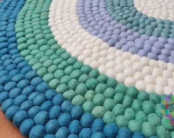 Alfombra circular de fieltro de lana hecha a mano para guardería.