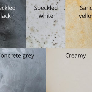 May include: A color palette featuring five distinct textures and hues. The image displays speckled black, speckled white, sand yellow, concrete grey, and creamy colors, each labeled with its respective name in black text.