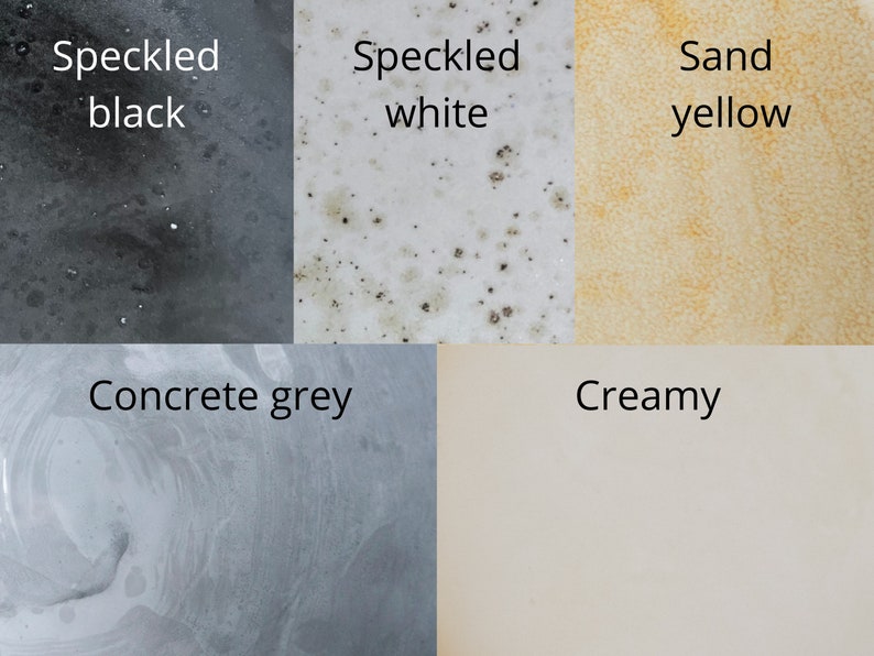 May include: A color palette featuring five distinct textures and hues. The image displays speckled black, speckled white, sand yellow, concrete grey, and creamy colors, each labeled with its respective name in black text.