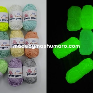 May include: A selection of colourful yarn skeins in shades of pink, yellow, white, and green, labelled "glow yarn." The image also shows the yarn glowing bright green in the dark. The website "madebymashumaro.com" is visible.