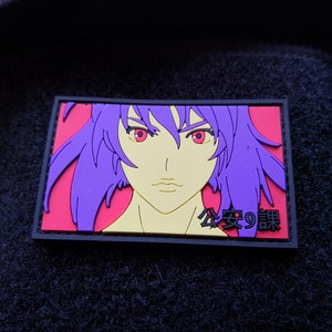 May include: A purple-haired anime character with red eyes is featured on a black and red patch. The patch has the text "公安9課" in black.