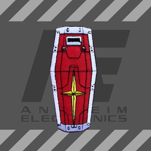 Könnte beinhalten: Roter und weißer gestickter Patch eines Schildes mit einem gelben Stern in der Mitte. Der Schild hat einen weißen Rand und einen weißen Streifen in der Mitte.