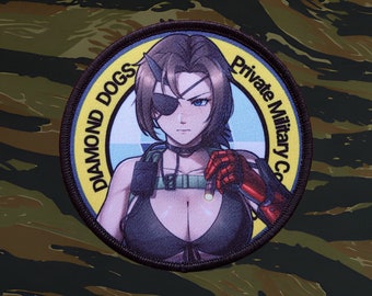 May include: A black and yellow circular patch with the text "Diamond Dogs Private Military Co." and an illustration of a woman with a black eyepatch and a red robotic arm.