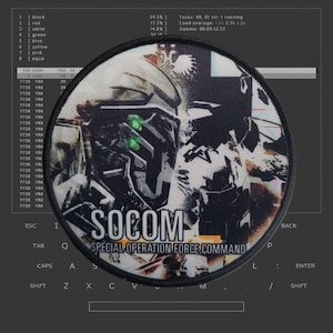 May include: A round, black and white patch with the text "SOCOM SPECIAL OPERATION FORCE COMMAND" in white. The patch features a stylized image of a soldier wearing a helmet and tactical gear.