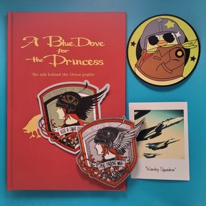 May include: A red book titled "A Blue Dove for the Princess" with the subtitle "The tale behind the Orion poplar". Three embroidered patches are attached to the front cover. The patches are red, white, and black with text and images. A yellow and brown cartoon patch of a pilot wearing a helmet and goggles is attached to a blue background.
