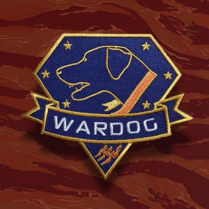 May include: Embroidered patch featuring a blue dog silhouette within a blue and gold hexagon. The word "WARDOG" is embroidered in white on a blue banner. The patch includes gold stars and a red and orange accent.