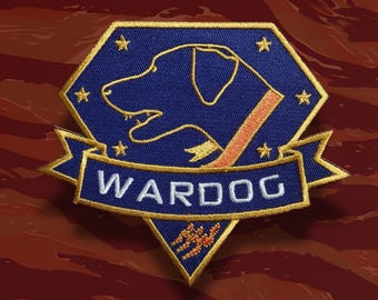 May include: Embroidered patch featuring a blue dog silhouette within a blue and gold hexagon. The word "WARDOG" is embroidered in white on a blue banner. The patch includes gold stars and a red and orange accent.