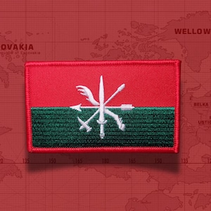 May include: A rectangular embroidered patch featuring a horizontal bicolor design with a red top half and a dark green bottom half. Centered on the patch is a white embroidered emblem depicting a cluster of crossed weapons and arrows.
