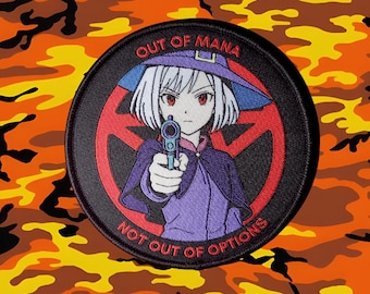 May include: Round patch featuring an anime-style character with white hair, a purple hat, and a purple outfit, holding a gun. The patch has the text "OUT OF MANA" and "NOT OUT OF OPTIONS" in white. The background is orange and yellow camouflage.