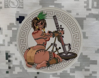 May include: A white circle with a gray Greek key border surrounds a colorful illustration of a woman in a tribal outfit holding a mortar. The woman is wearing a brown and yellow skirt, a red and black top, and a green headdress. The mortar is gray and black with a red handle.