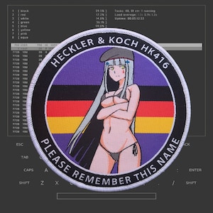 May include: A round, purple and black patch with a white border. The patch features a cartoon woman with white hair and a black beret. The woman is wearing a black bikini and has her arms crossed. The text "HECKLER & KOCH HK416" is printed in white on the patch. The text "PLEASE REMEMBER THIS NAME" is printed in white on the bottom of the patch.