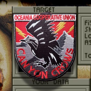 May include: A shield-shaped embroidered patch featuring a black crow in the centre against a red and grey background. The text "OCEANIA COOPERATIVE UNION" is at the top, and "CANYON CROWS" is at the bottom in red. Two yellow lightning bolts are visible.