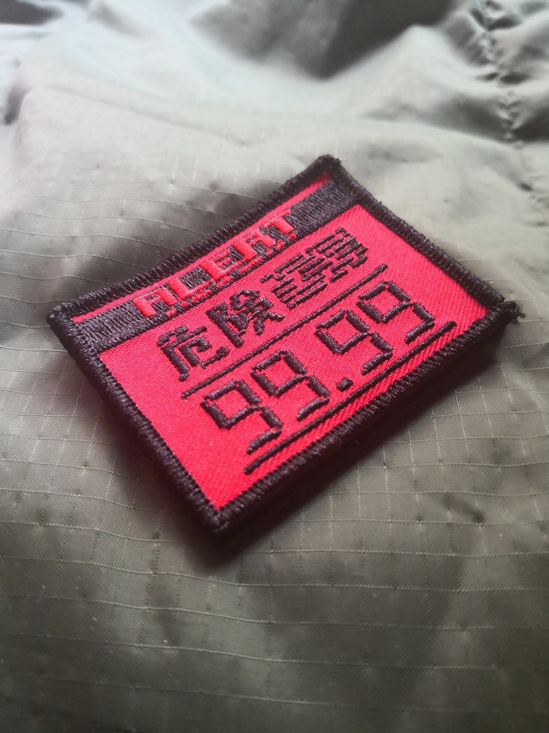 May include: Red and black embroidered patch with the text "REMARKABLE 99.99".