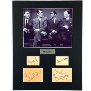 May include: Black framed print featuring a black and white photo of four men in suits. Below the photo are four smaller images with signatures. The text "The Rat Pack" is centered below the photo.