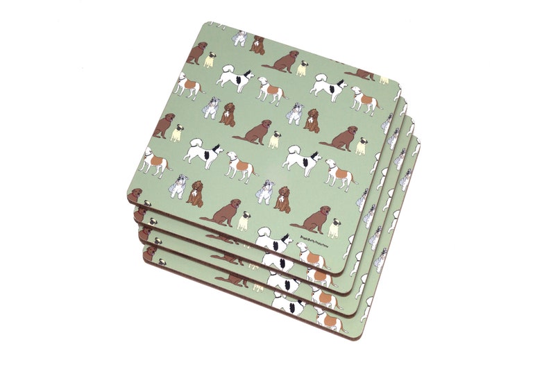 May include: Set of four green square coasters with a pattern of various dog breeds in different colors. The coasters are made of cork.