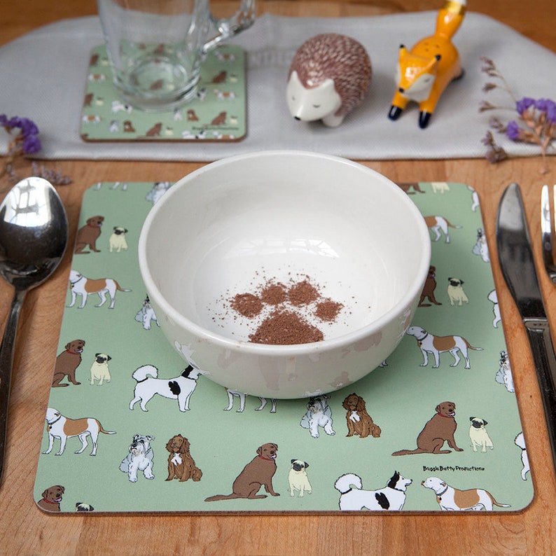 Square olive coloured placemats, with dog pattern. Wipe clean surface with a cork backing