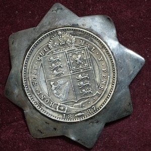 Vintage brooch made from a 1887 .925 silver British shilling coin Queen Victoria jubilee portrait placed within 8 pointed star mount