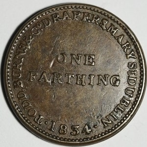 May include: A bronze coin with the inscription "One Farthing" and the text "MARY STUDD, DUBLIN" around the edge. The coin also has the date "1834" and the text "TO. BURNS & CO. DRAPERS" around the edge.