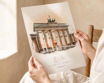 May include: A rectangular art print featuring a watercolor illustration of the Brandenburg Gate in Berlin, Germany. The print includes the text Berlin, the coordinates 52.5200 N, 13.4050 E, and the word Germany in a clean, minimalist font.