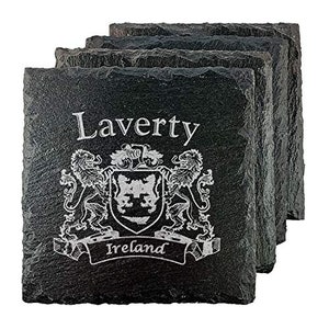 May include: A stack of four square black slate coasters. Each coaster is engraved with the name "Laverty", a coat of arms design, and the word "Ireland". The coasters have a rough, natural edge.