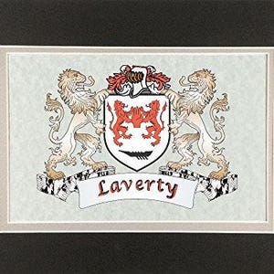 May include: A framed heraldic crest featuring a shield with two red lions, flanked by two beige lions. The name "Laverty" is displayed on a white banner below the shield. The frame is white with a black border.