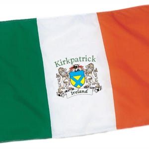 May include: Irish flag with green, white, and orange vertical stripes. The white stripe features a coat of arms with the name "Kirkpatrick" and the word "Ireland". The flag is rectangular and has a grommet on the left side.