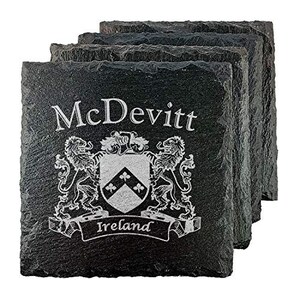 May include: A stack of four square black slate coasters. Each coaster is engraved with the name "McDevitt", a family crest, and the word "Ireland". The design is in a silver color.