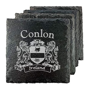 May include: A stack of four black slate coasters. Each coaster features the name "Conlon" and a family crest with the word "Ireland" in white lettering. The coasters have a rough, natural edge.