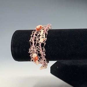 Pink wire bracelet with fish image 1