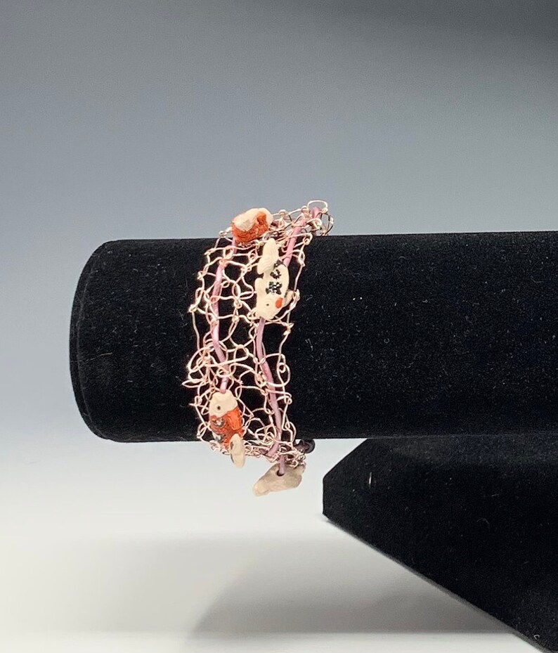 Pink wire bracelet with fish image 1