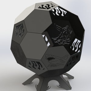 Puede incluir: Hoguera de metal negro con forma de balón de fútbol con recortes de una ballena, un tiburón y llamas. La hoguera tiene un soporte con tres patas.